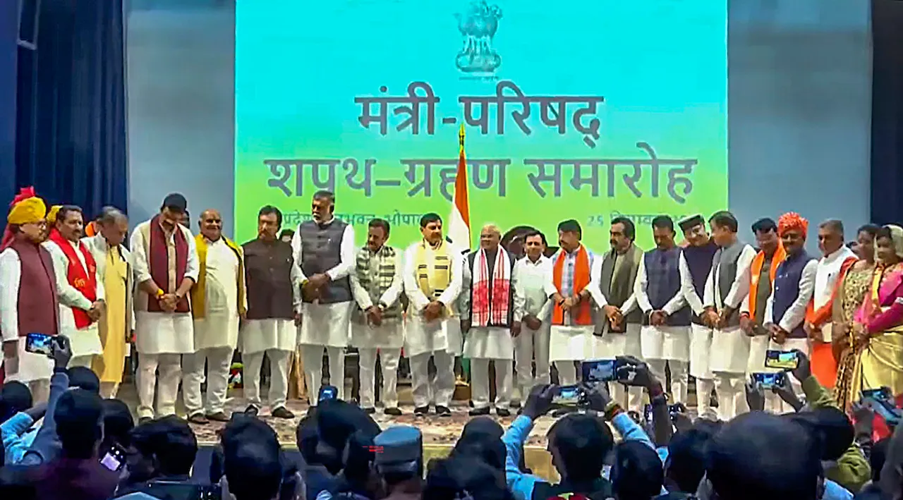 Madhya Pradesh Governor Mangubhai Patel and Chief Minister Mohan Yadav pose for a group photo with the newly inducted ministers of the State Cabinet, after the swearing-in ceremony at Raj Bhawan, in Bhopal, Monday, Dec. 25, 2023