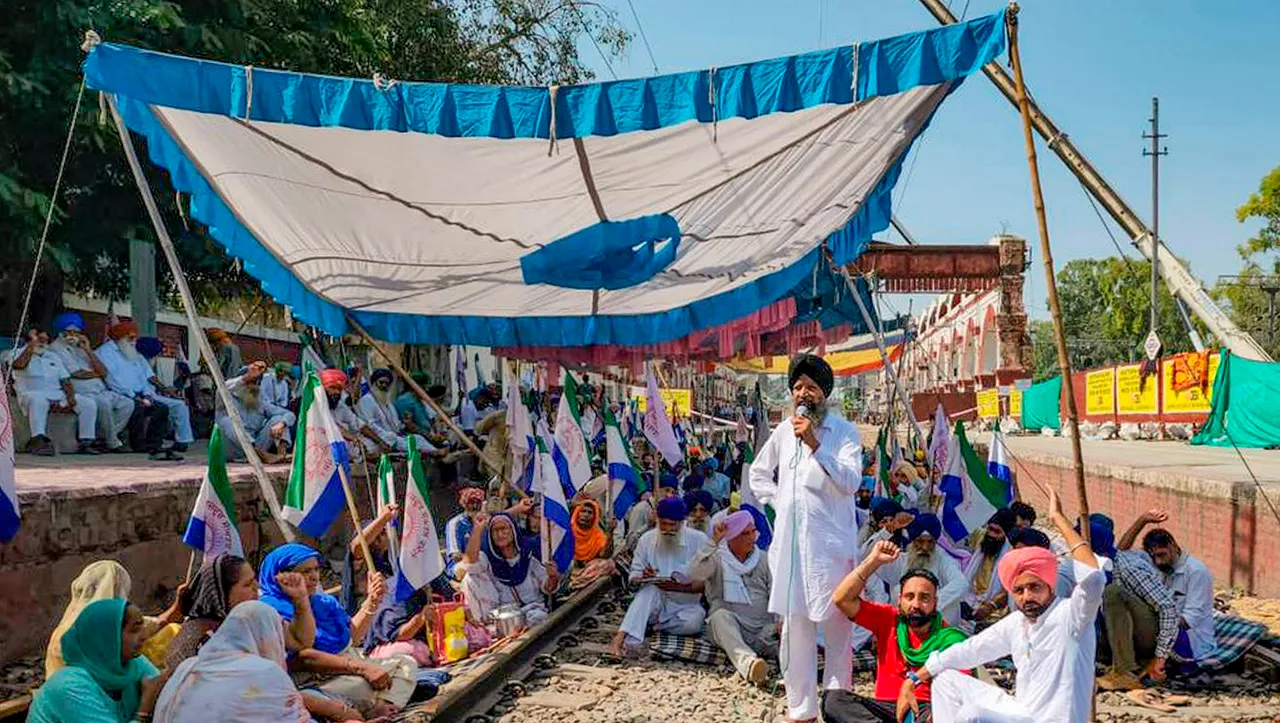 Farmers shout slogans while blocking a railway track during a ‘Rail Roko’ protest to press their demands such as a financial package for losses caused by recent floods, legal guarantee to minimum support price (MSP) and debt waiver, at a railway station, in Jalandhar,