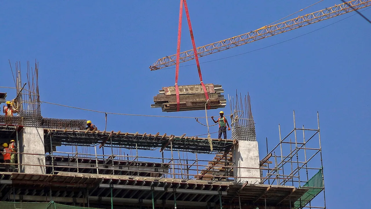 Workers at a construction site, ahead of the presentation of the Interim Budget 2024 by Union Finance Minister Nirmala Sitharaman, in Bengaluru