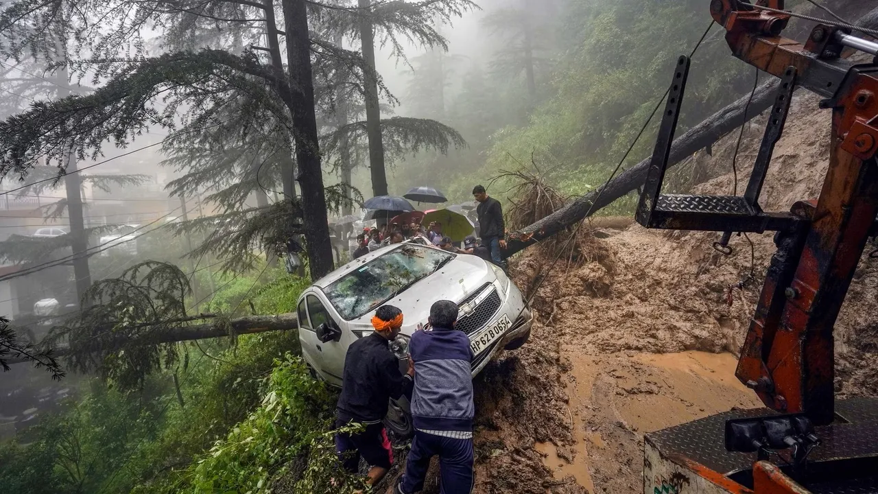 People pull a vehicle to a safer place after a landslide following heavy rainfall, in Shimla, Sunday, Aug 13, 2023