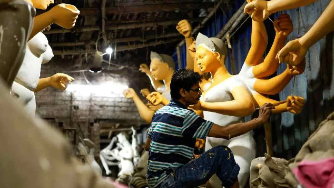 An artisan paints an idol of the Hindu goddess Durga inside a workshop ahead of the Durga Puja festival in Calcutta