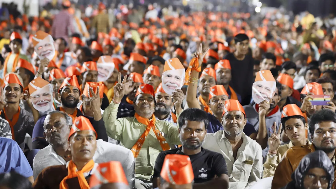 Supporters of BJP attend public meeting of Union Home Minister Amit Shah ahead of Gujarat Assembly election in Ahmedabad, Tuesday