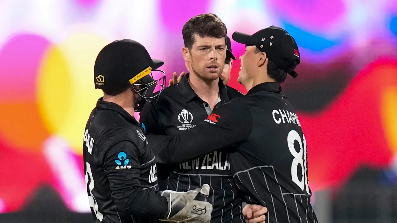 New Zealand's Mitchell Santner celebrates with teammates after taking the wicket of Afghanistan’s Mohammad Nabi