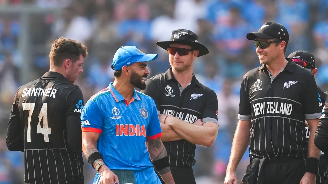 India's Virat Kohli with New Zealand's players during the ICC Men's Cricket World Cup semifinal match between India and New Zealand, at Wankhede Stadium in Mumbai