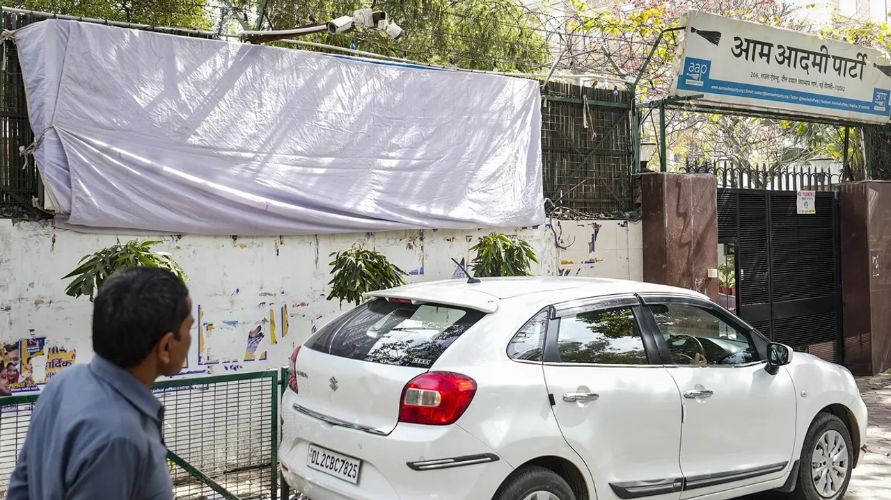 A covered political banner outside AAP office after the Model Code of Conduct was enforced following the announcement of the schedule of Lok Sabha elections, in New Delhi, Sunday, March 17, 2024.