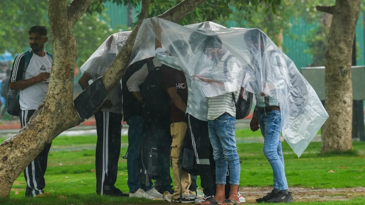 People shield themselves during rains, in New Delhi (File image)