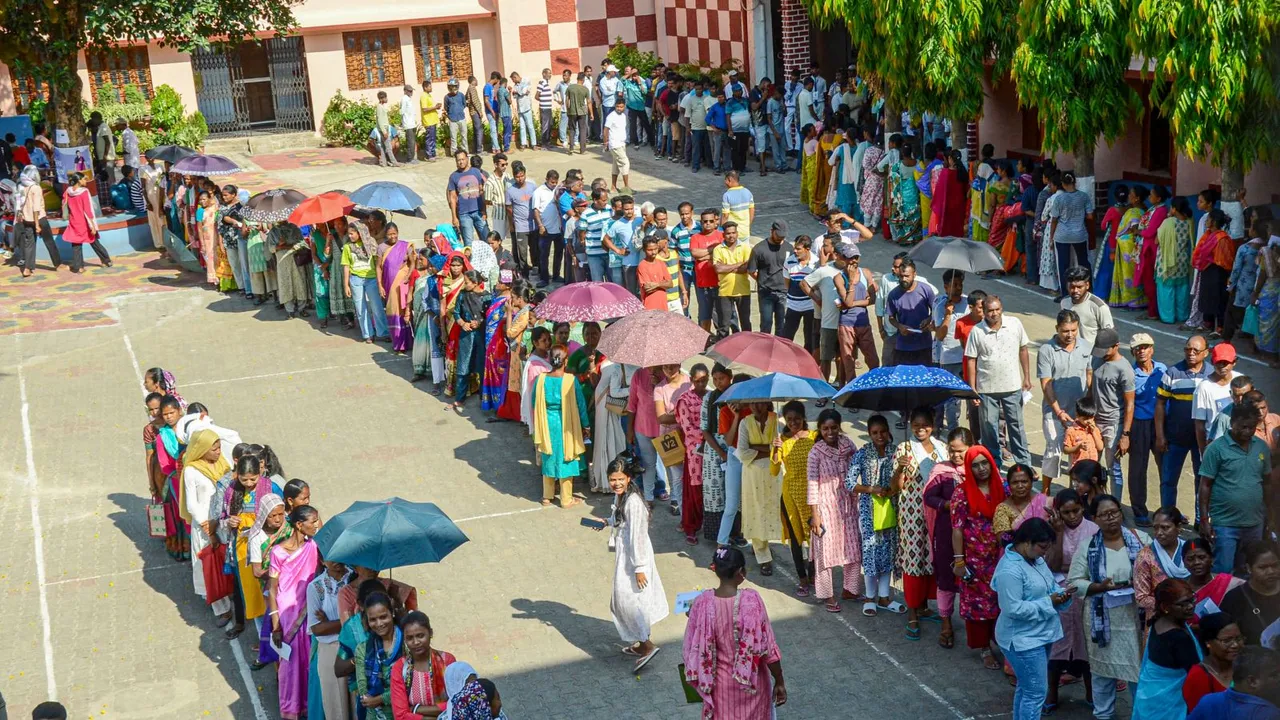 People wait in queues to cast their votes at a polling booth during the sixth phase of Lok Sabha elections, in Ranchi, Saturday, May 25, 2024