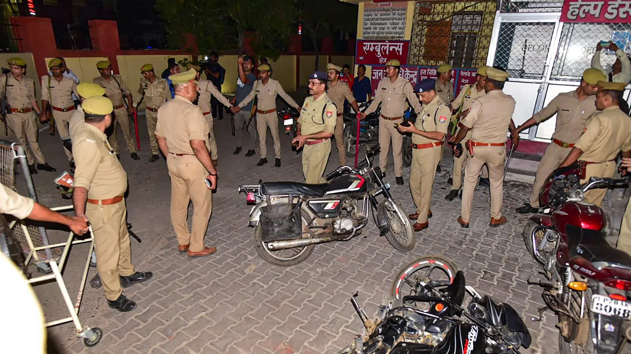 Police personnel at the site where Gangster-turned-politician Atiq Ahmed and his brother Ashraf Ahmed were shot dead while they were being taken for a medical checkup in Prayagraj on April 15