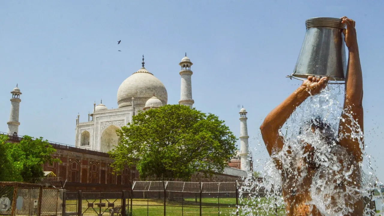 A man pours water on himself due to the scorching heat, in Agra, Tuesday, April 16, 2024