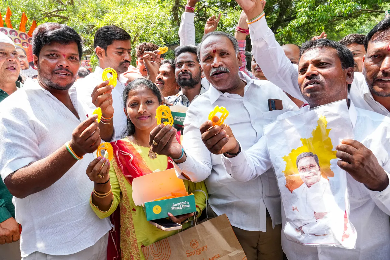 Supporters of senior Congress leader Siddaramaiah celebrates outside his residence, in Bengaluru