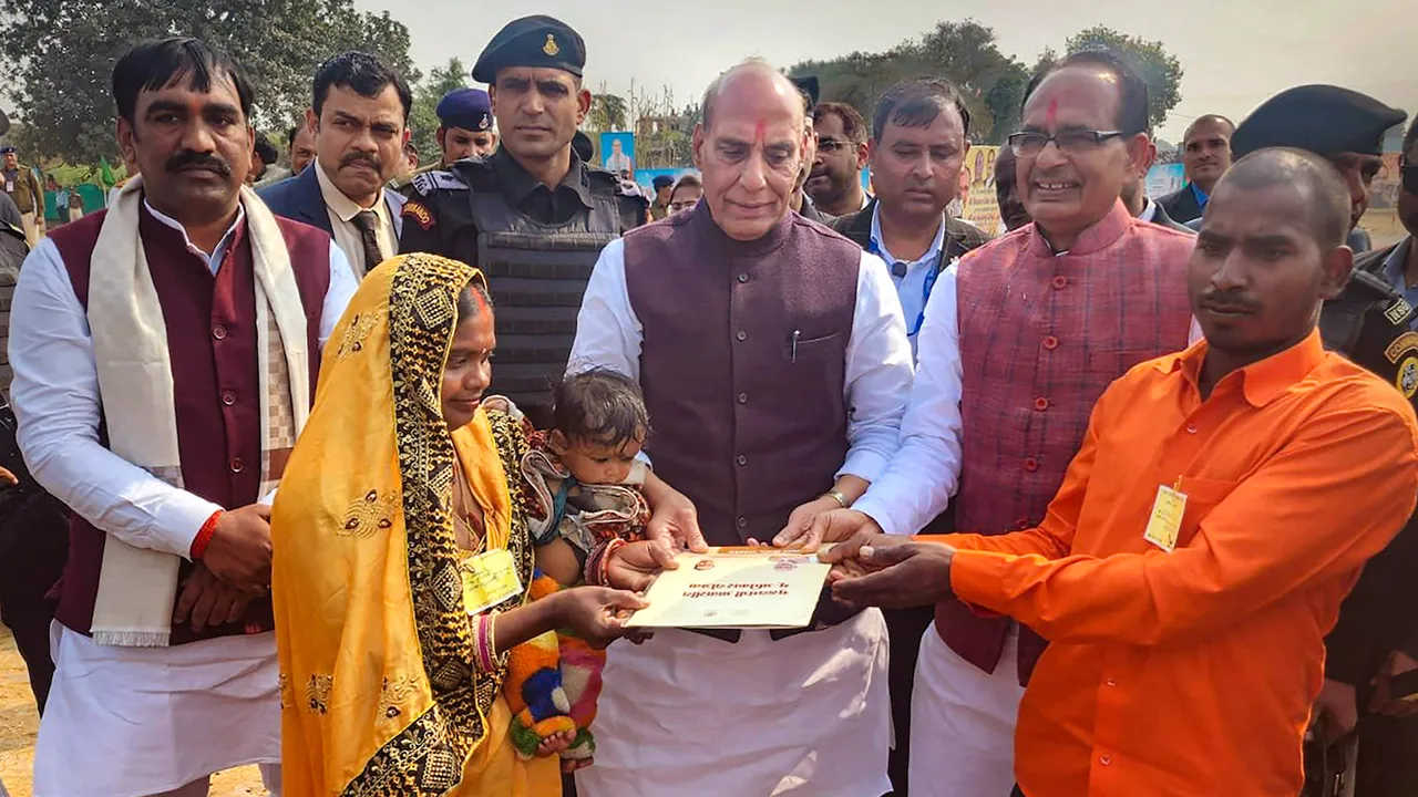 Defence Minister Rajnath Singh with Madhya Pradesh Chief Minister Shivraj Singh Chouhan during a programme presenting land leases to beneficiaries under Chief Minister's Residential Land Rights Scheme  in Singrauli on, Sunday