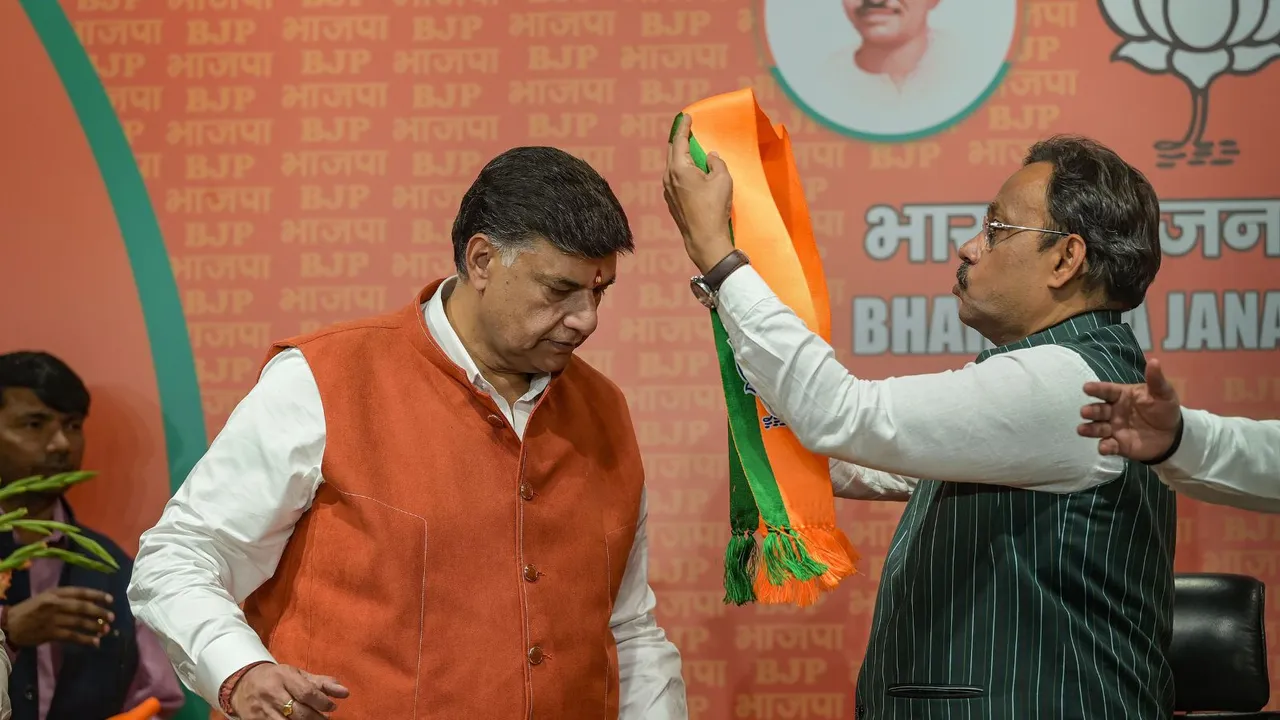 Former Congress MLA from Kanpur Ajay Kapoor being felicitated by BJP National General Secretary Vinod Tawde after the former joined BJP, at the party headquarters, in New Delhi