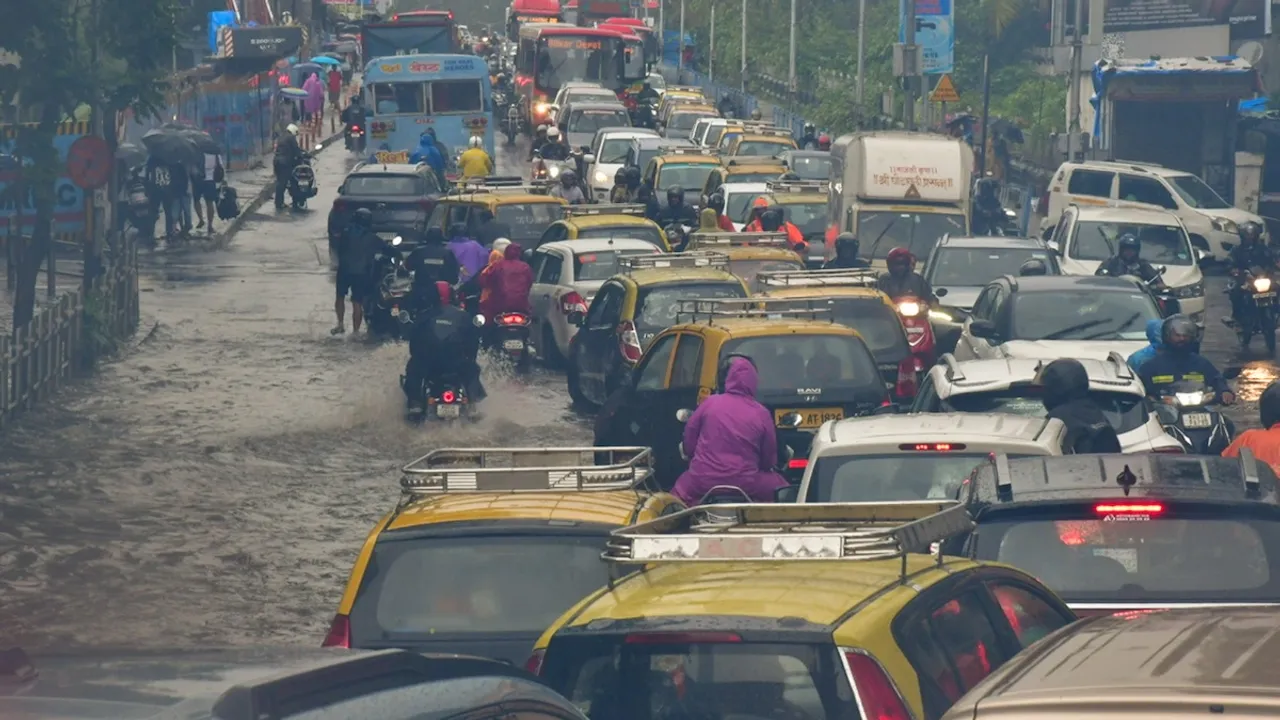  Vehicles move on a waterlogged road after heavy monsoon rain, at Dadar in Mumbai, Sunday, July 21, 2024.