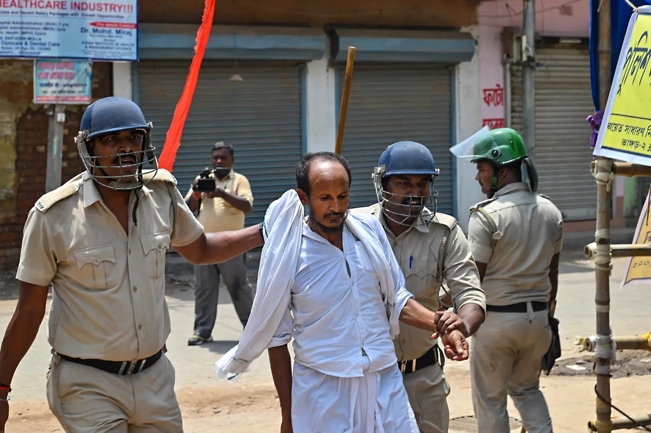 Police detain miscreants after a violent clash broke out between workers of the Indian Secular Front (ISF) and the Trinamool Congress (TMC) during nomination filing