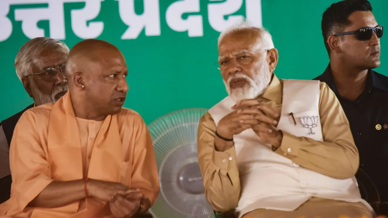 Prime Minister Narendra Modi with Uttar Pradesh Chief Minister Yogi Adityanath during a public meeting ahead of Lok Sabha elections, in Pilibhit, Tuesday, April 9, 2024