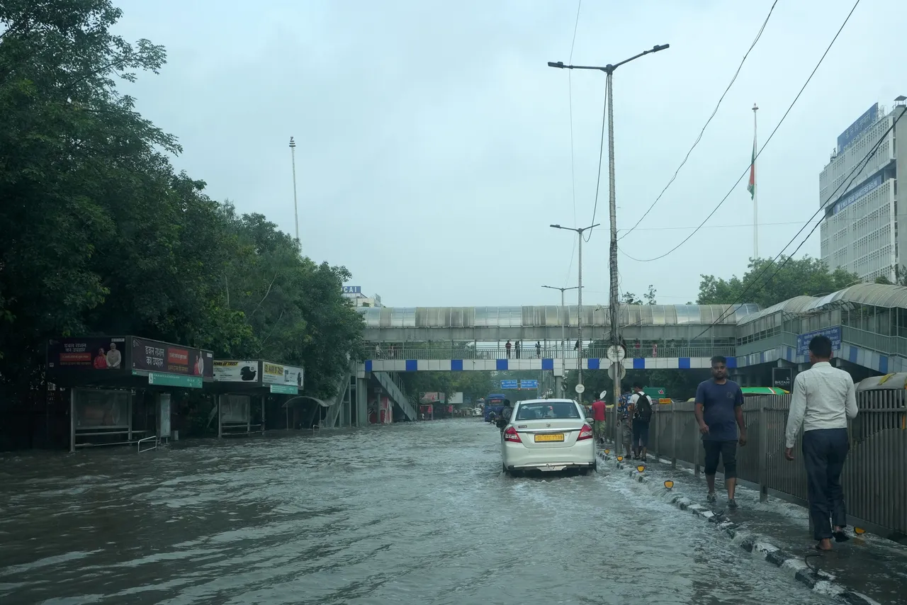 Vehicles pass through a waterlogged road near ITO, in New Delhi, Friday.jpg