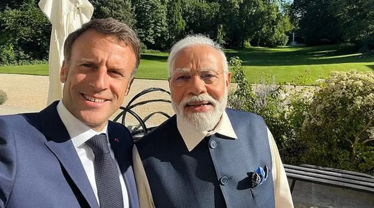 French President Emmanuel Macron takes selfie with Prime Minister Narendra Modi 