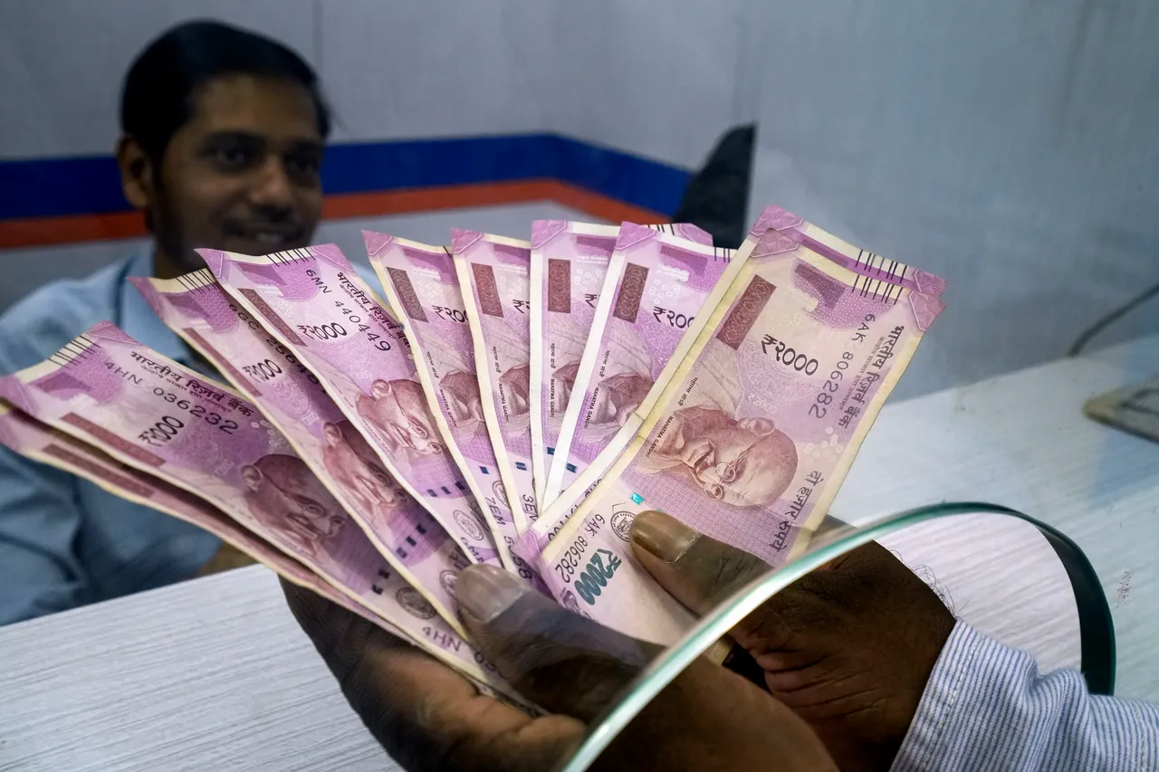 A man deposits Rs 2000 currency notes at a bank in New Delhi