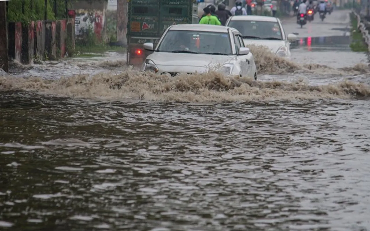 Vehicles wade through a waterlogged Delhi- Gurugram Expressway service road after rains in Gurugram, Thursday