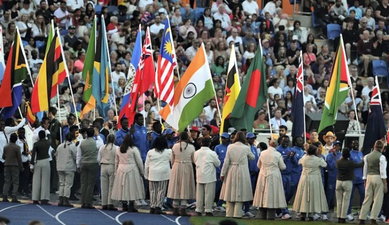 Flagbearers of participating countries hold the national flags of their respective countries during the closing ceremony of the Commonwealth Games 2022 (CWG), at Alexander Stadium in Birmingham, UK, Monday