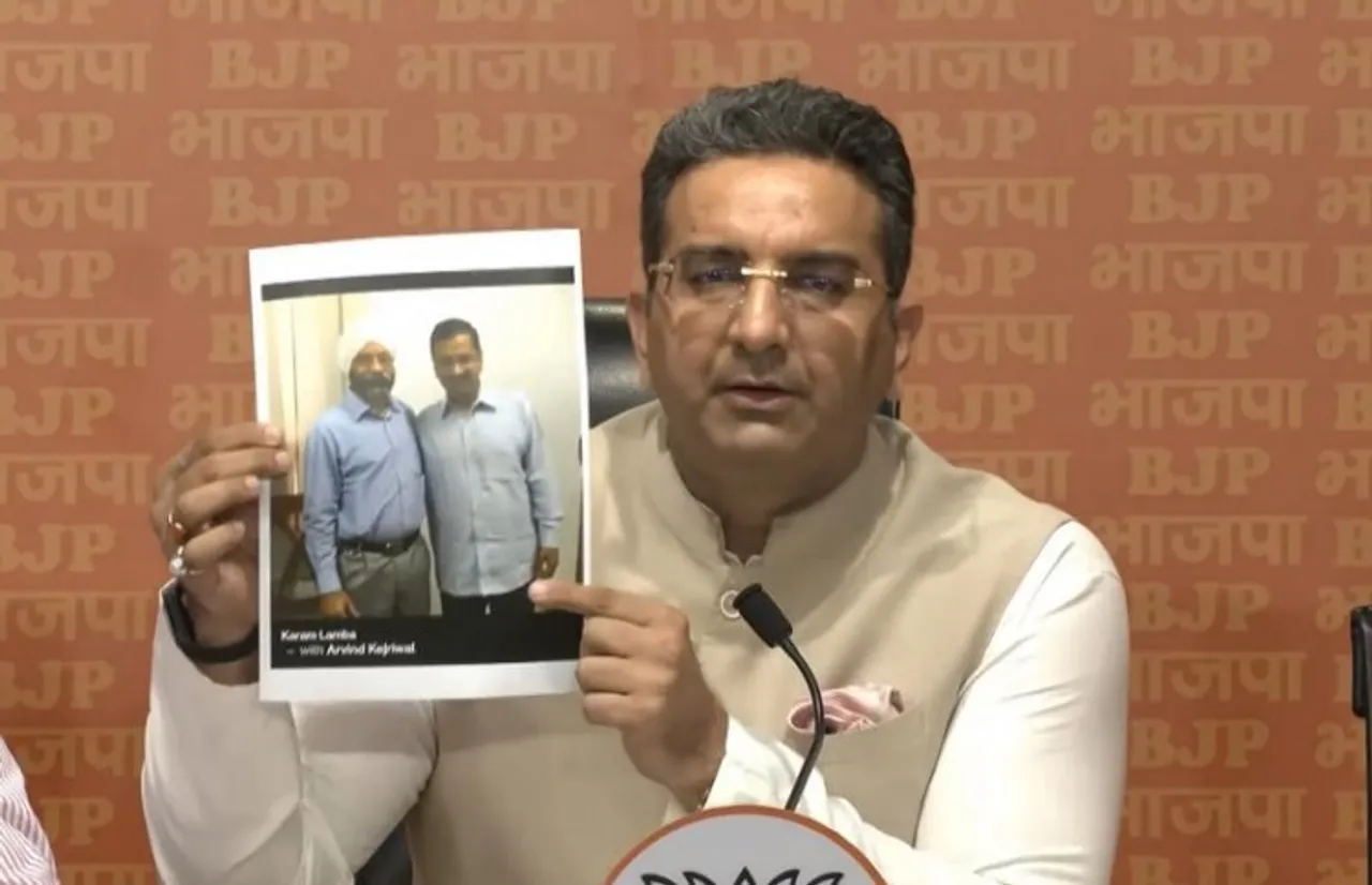 BJP spokesperson Gaurav Bhatia shows picture of Arvind Kejriwal with liquor trader