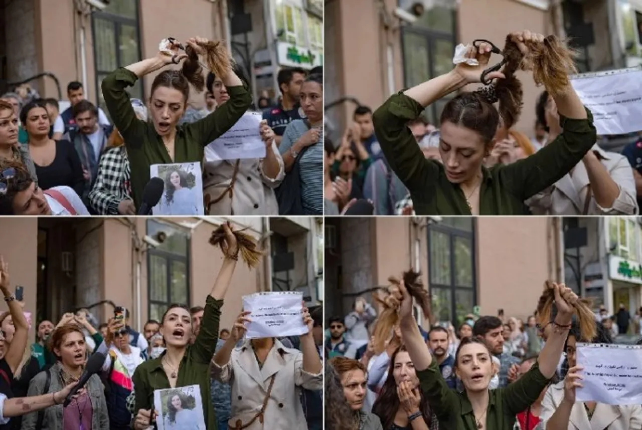 A woman cuts her hair outside Iranian embassy in Istanbul in support of Iranian women protesting  against the hijab