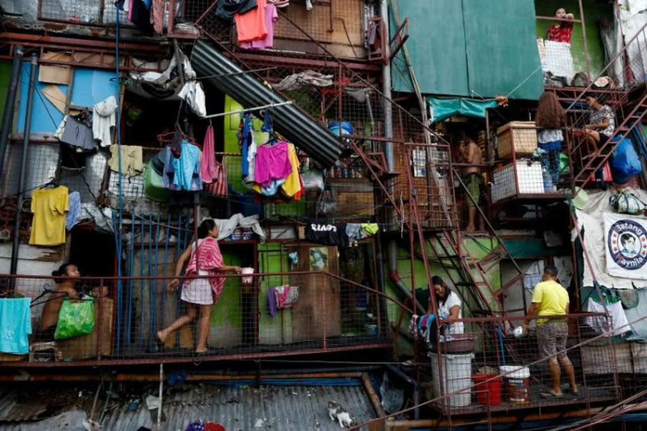 Residents of a small apartment building do house chores outside their units, amid the lockdown to contain the coronavirus disease (COVID-19), in a slum area in Tondo, Manila, Philippines. 