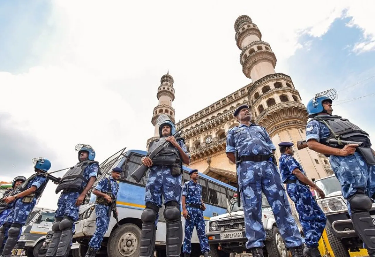 Rapid Action Force (RAF) personnel stand guard at the Charminar during Friday prayers in Hyderabad, Friday