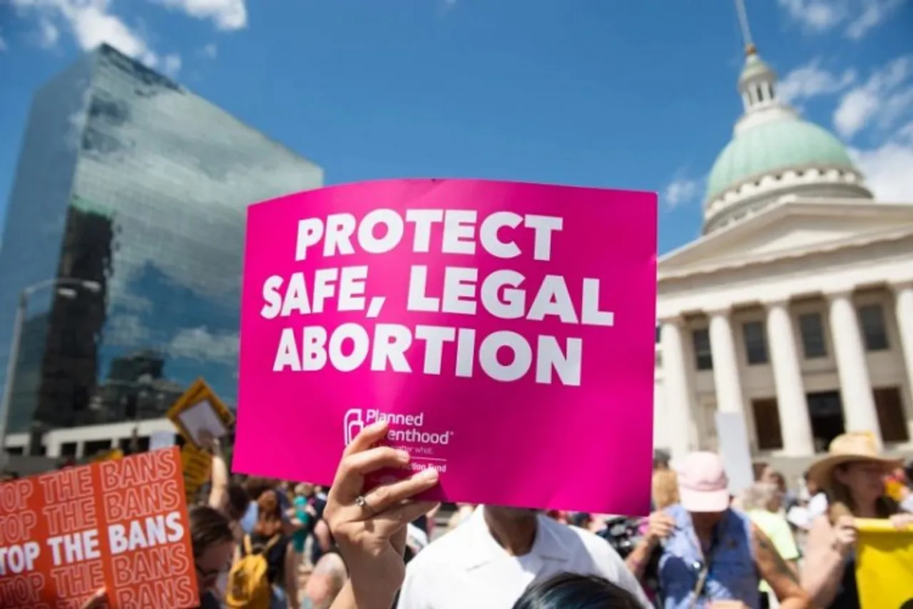 Banner of "PROTECT, SAFE, LEGAL ABORTION" by a protestor against the Supreme Court decision of Abortion Act in the US