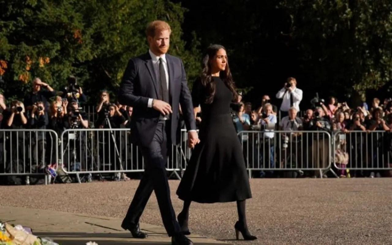 Prince Harry along with his wife Meghan Markle viewing thousands of floral tributes left for the Queen at Windsor Castle