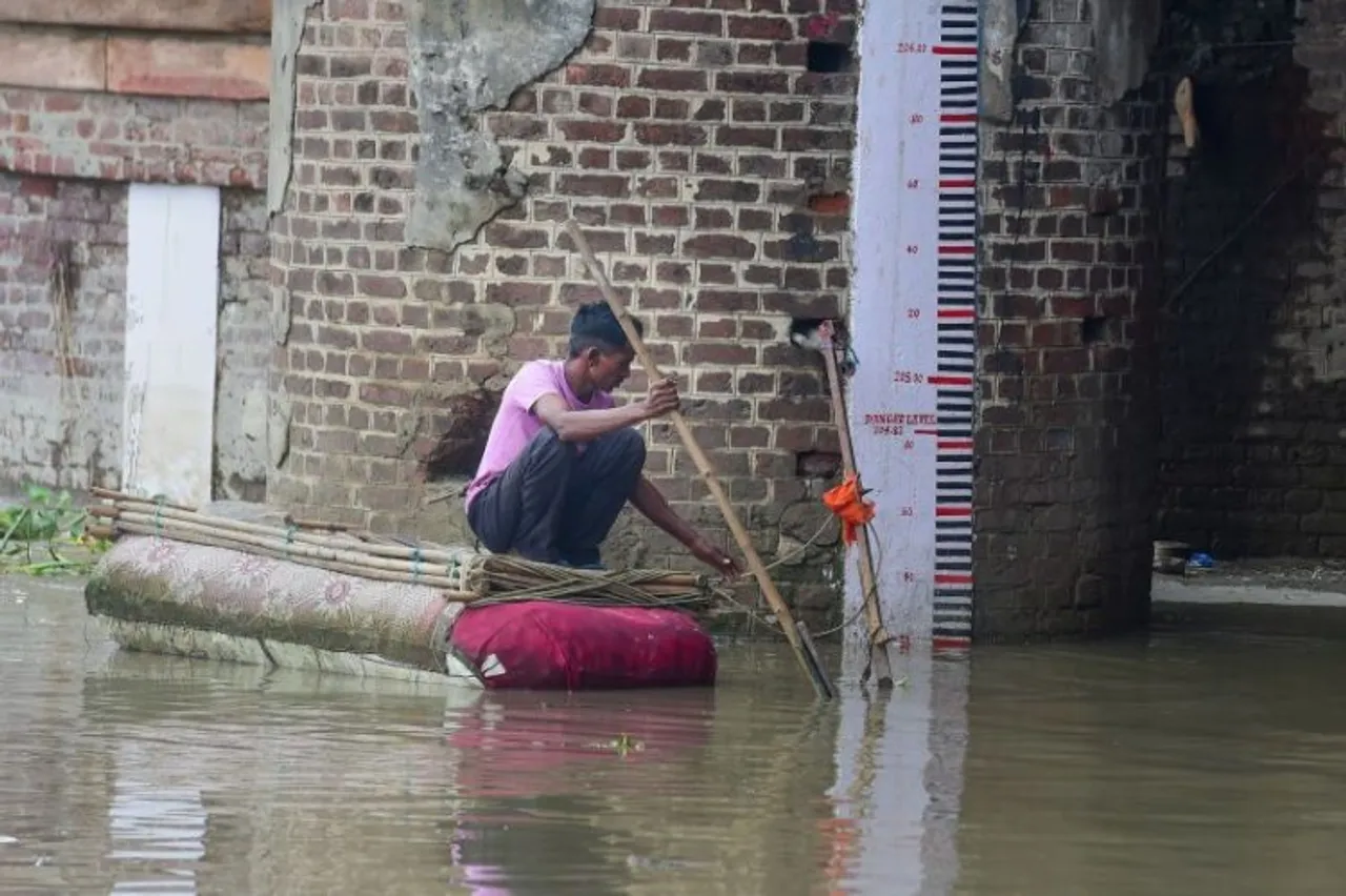 A man rows his improvised boat near the scale at the Yamuna River