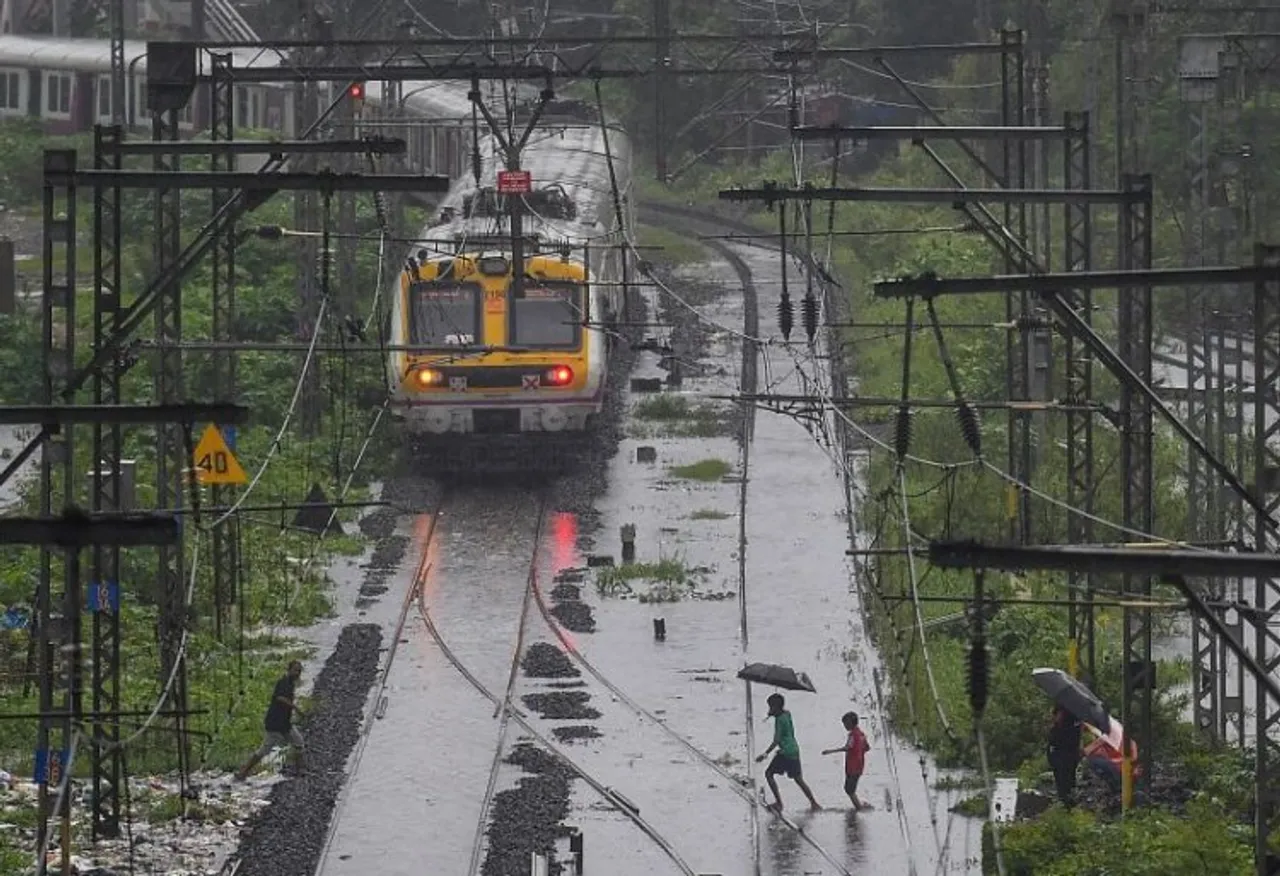 A local train runs on flooded tracks between Kurla and Tilak Nagar, following heavy monsoon rains, in Mumbai