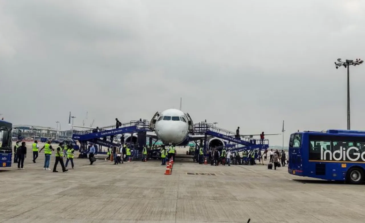 Ramps being attached to an IndiGo plane at the airport in New Delhi, Thursday, Aug 4, 2022. IndiGo on Thursday announced it would disembark passengers from three doors of the plane, allowing the flyers to quickly get off the aircraft