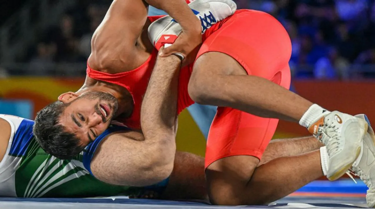 India's Naveen Kumar competes against Pakistan's Muhammad Sharif Tahir in the final of Mens Freestyle Wrestling 74kg event at the CWG, in Birmingham, UK, Saturday