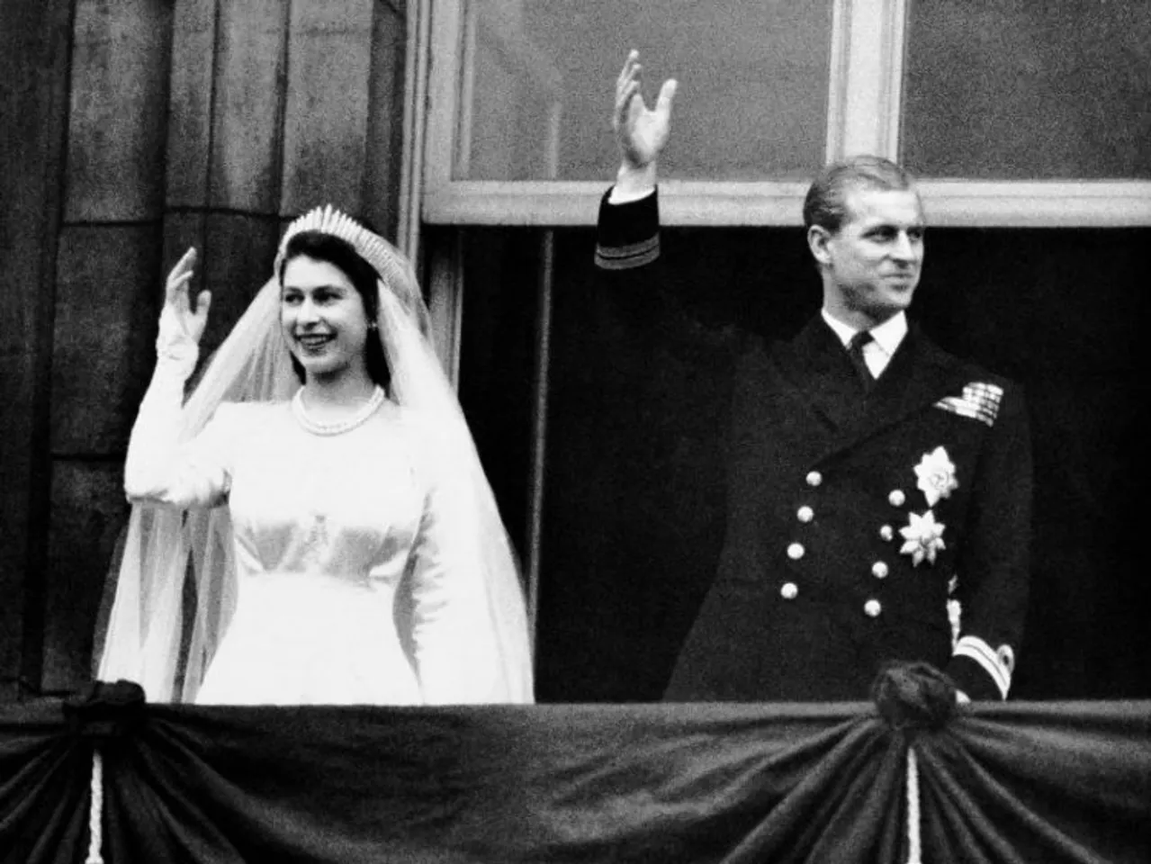 Britain's Princess Elizabeth and Prince Philip, the Duke of Edinburgh wave to the crowds from the balcony of Buckingham Palace in London, after their wedding, Nov. 20, 1947. Queen Elizabeth II, Britain's longest-reigning monarch and a rock of stability across much of a turbulent century, has died. She was 96. Buckingham Palace made the announcement in a statement on Thursday Sept. 8, 2022. (AP Photo, File)
