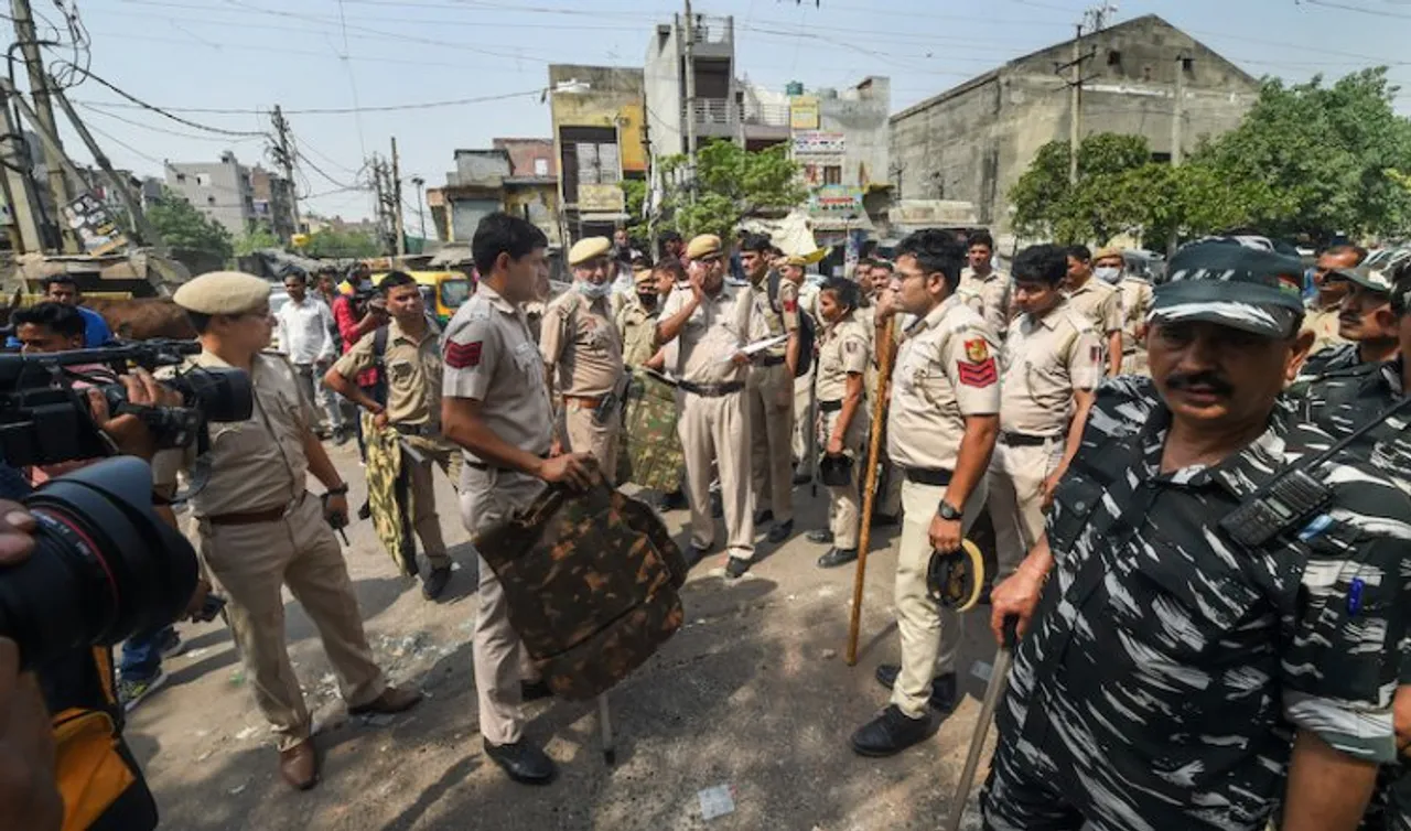 Delhi police personel keeping vigil in Jahangir Puri of Delhi after clashes between two groups