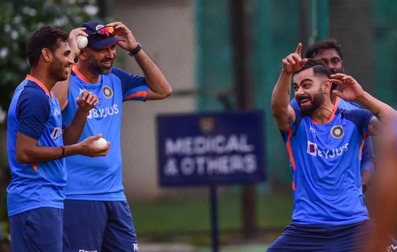  Indian cricketers Bhuvneshwar Kumar and Virat Kohli with support staff during a practice session ahead of the first match