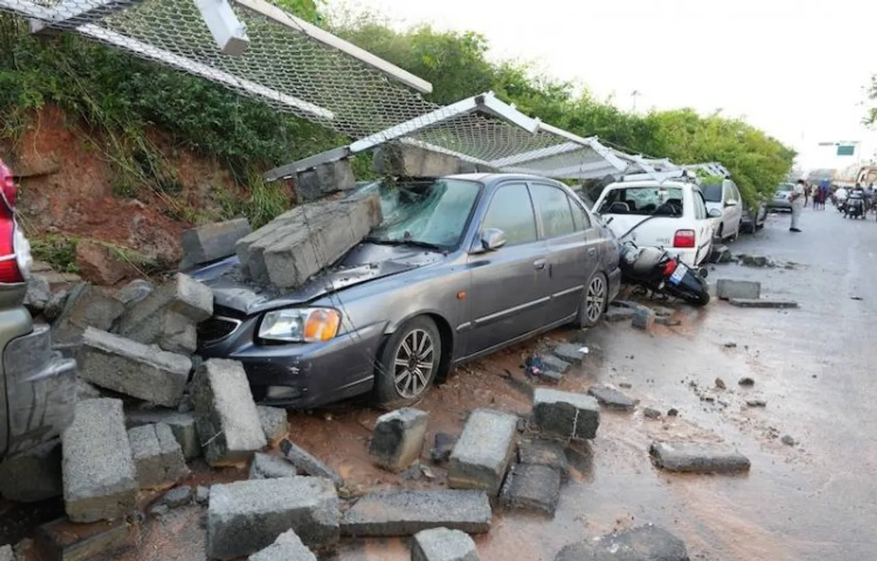 Damaged cars after the retaining wall of Bengaluru Metro Rail Corporation Limited (BMRCL) collapsed due to heavy rainfall, in Bengaluru, Thursda