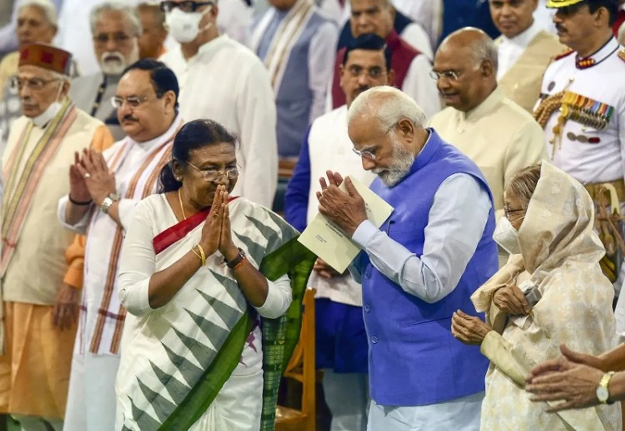 President Droupadi Murmu exchanges greetings with Prime Minister Narendra Modi during her oath ceremony in the Central Hall of Parliament, in New Delhi