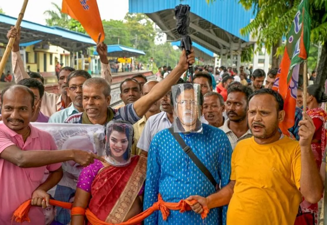 BJP supporters wearing masks of former WB minister Partha Chatterjee and his aide Arpita Mukherjee, gather to board a Sealdah-bound train to participate in the partys Nabanna Abhijan (March to Secretariat), in Nadia