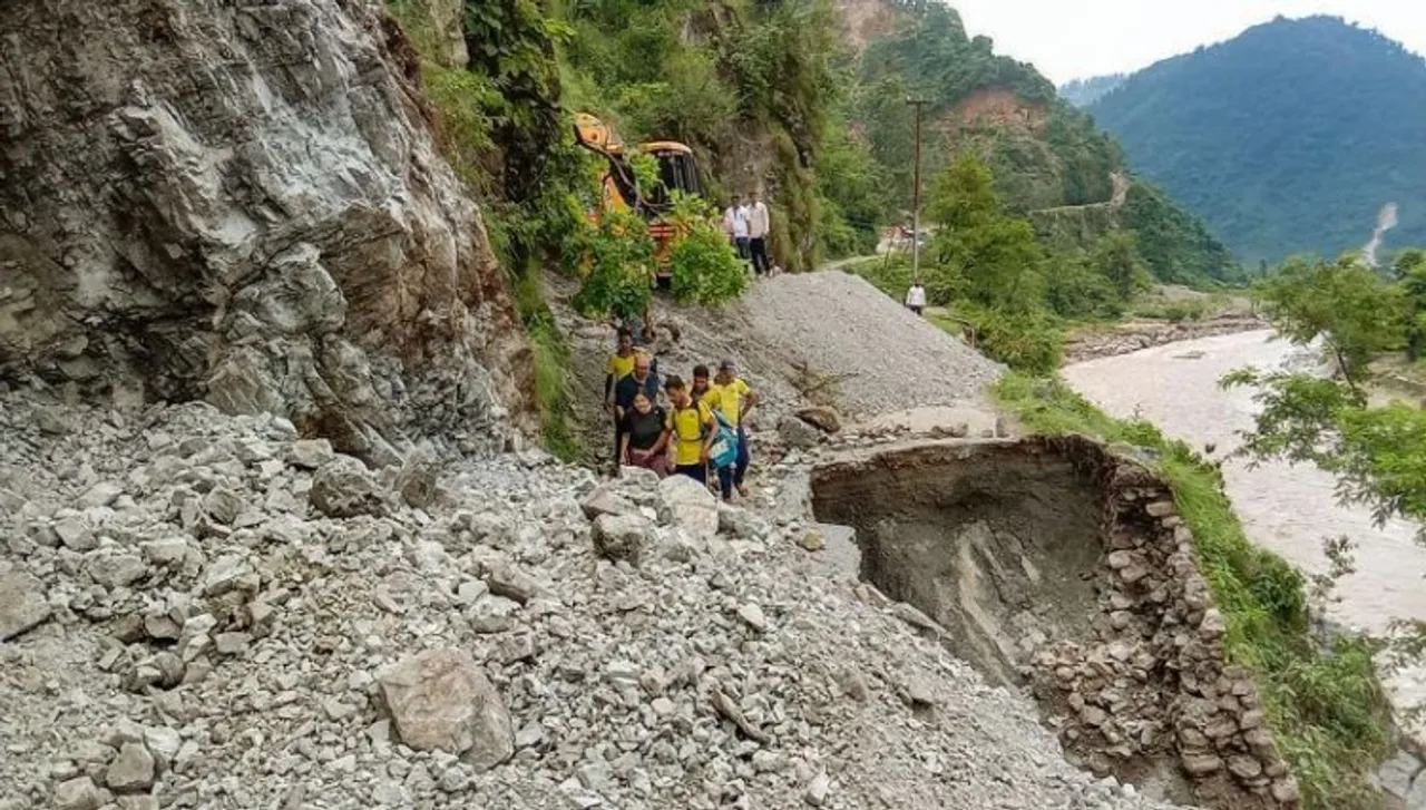 SDRF personnel conduct a rescue operation to evacuate stranded tourists following monsoon rainfall, in Tehri Garhwal