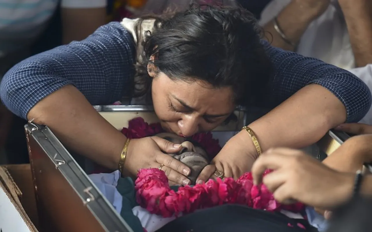 Mother of Kartik mourns besides the mortal remains of her son in Ghaziabad on April 16