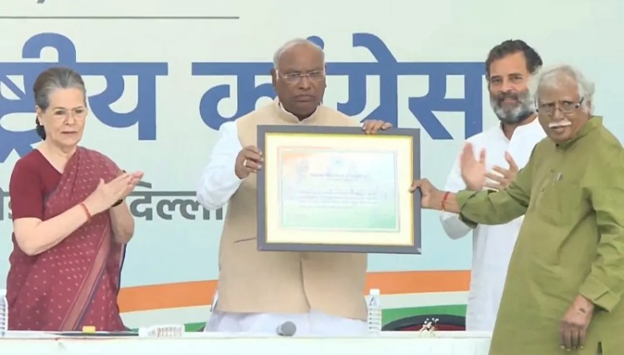 Newly-elected Congress President Mallikarjun Kharge being presented certificate of election by Congress Central Election Authority Chairman Madhusudan Mistry as former party president Sonia Gandhi and party MP Rahul Gandhi looks on during a ceremony, at AICC Headquarters in New Delhi