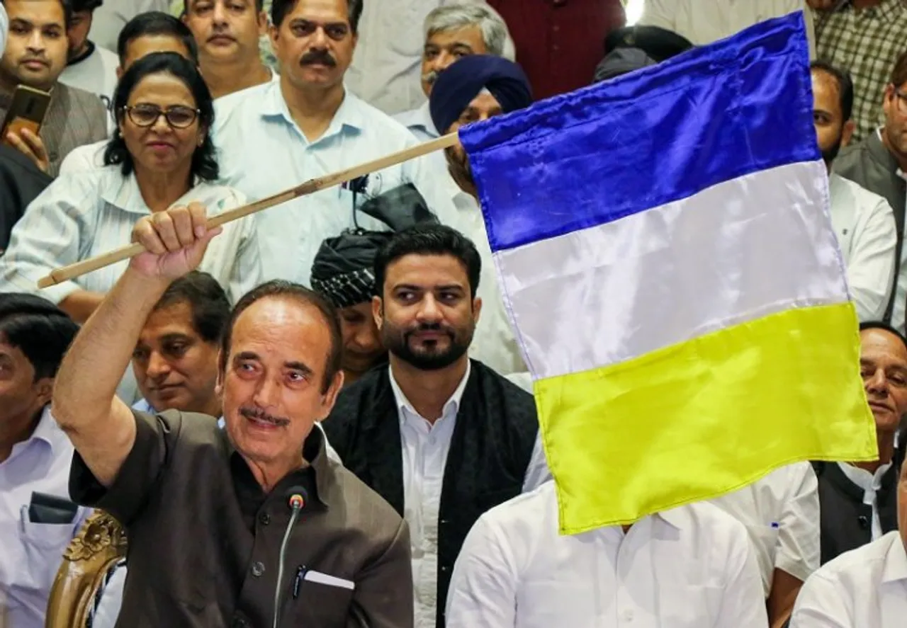 Former Jammu and Kashmir chief minister Ghulam Nabi Azad unveils the flag of his new Democratic Azad Party during a press conference, in Jammu