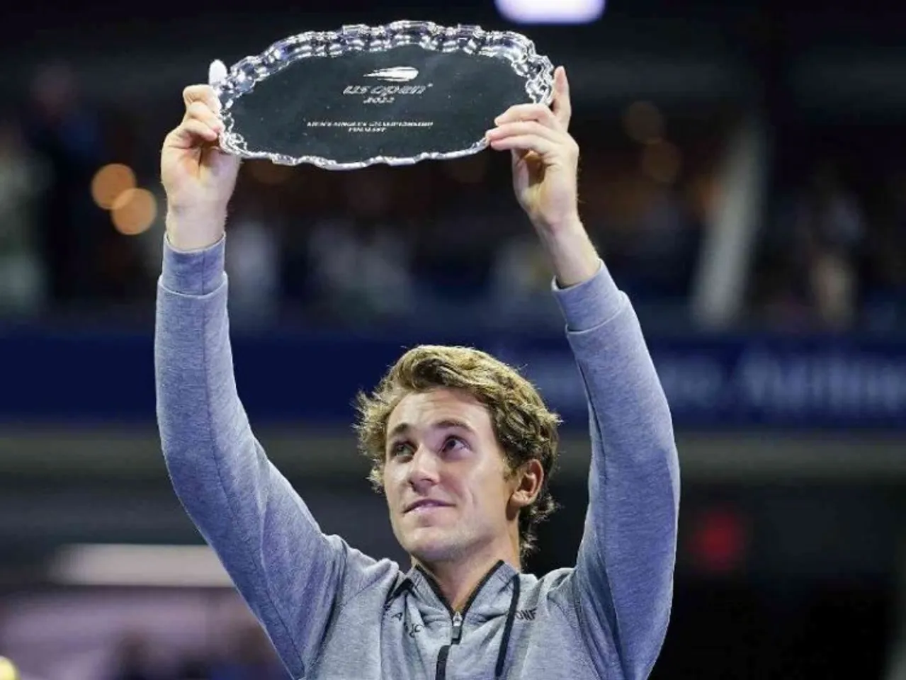 Casper Ruud of Norway, holds up the runner-up trophy after losing to Carlos Alcaraz, of Spain, in the men's singles final of the U.S. Open tennis championships
