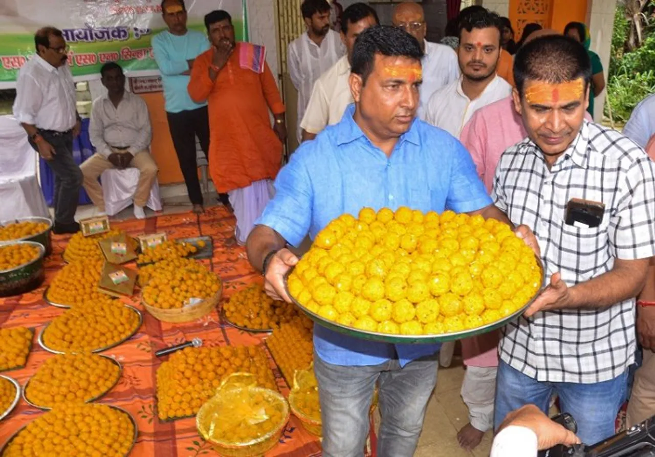 Members of Maharana Pratab Seva Foundation prepare laddoos to be distributed among locals to celebrate the oath-taking ceremony of President-elect Droupadi Murmu, in Ranchi