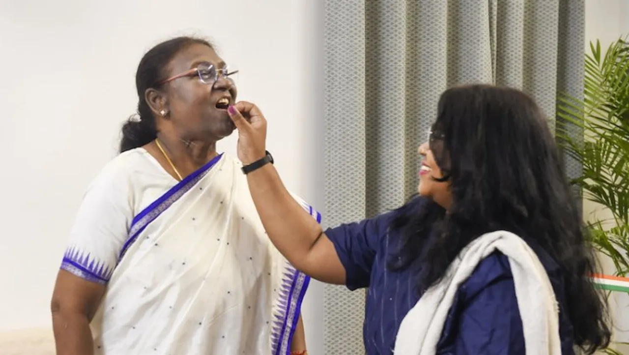 President-elect Droupadi Murmu celebrates with her daughter Itishri Murmu, in New Delhi, Thursday
