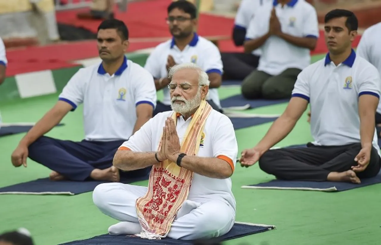 Prime Minister Narendra Modi performs yoga at a mass yoga session to celebrate the 8th International Day of Yoga, at Mysore Palace in Mysuru
