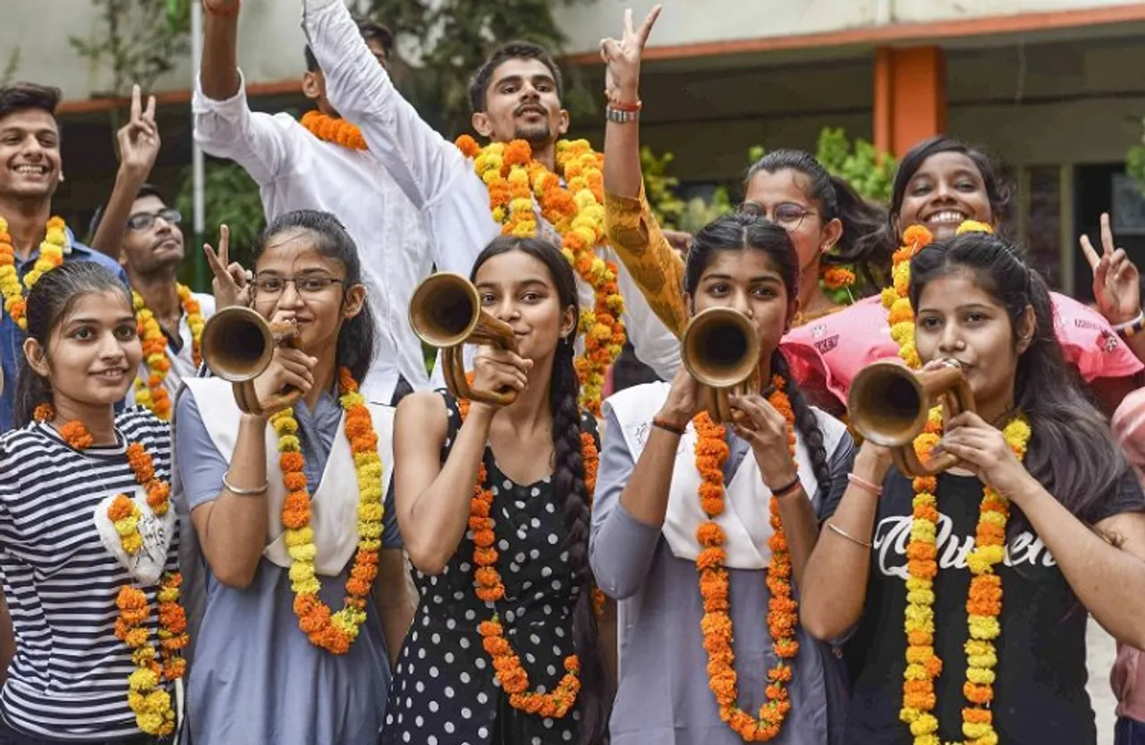 Students celebrate their success after the UP Board declared its 10th class results, in Prayagraj