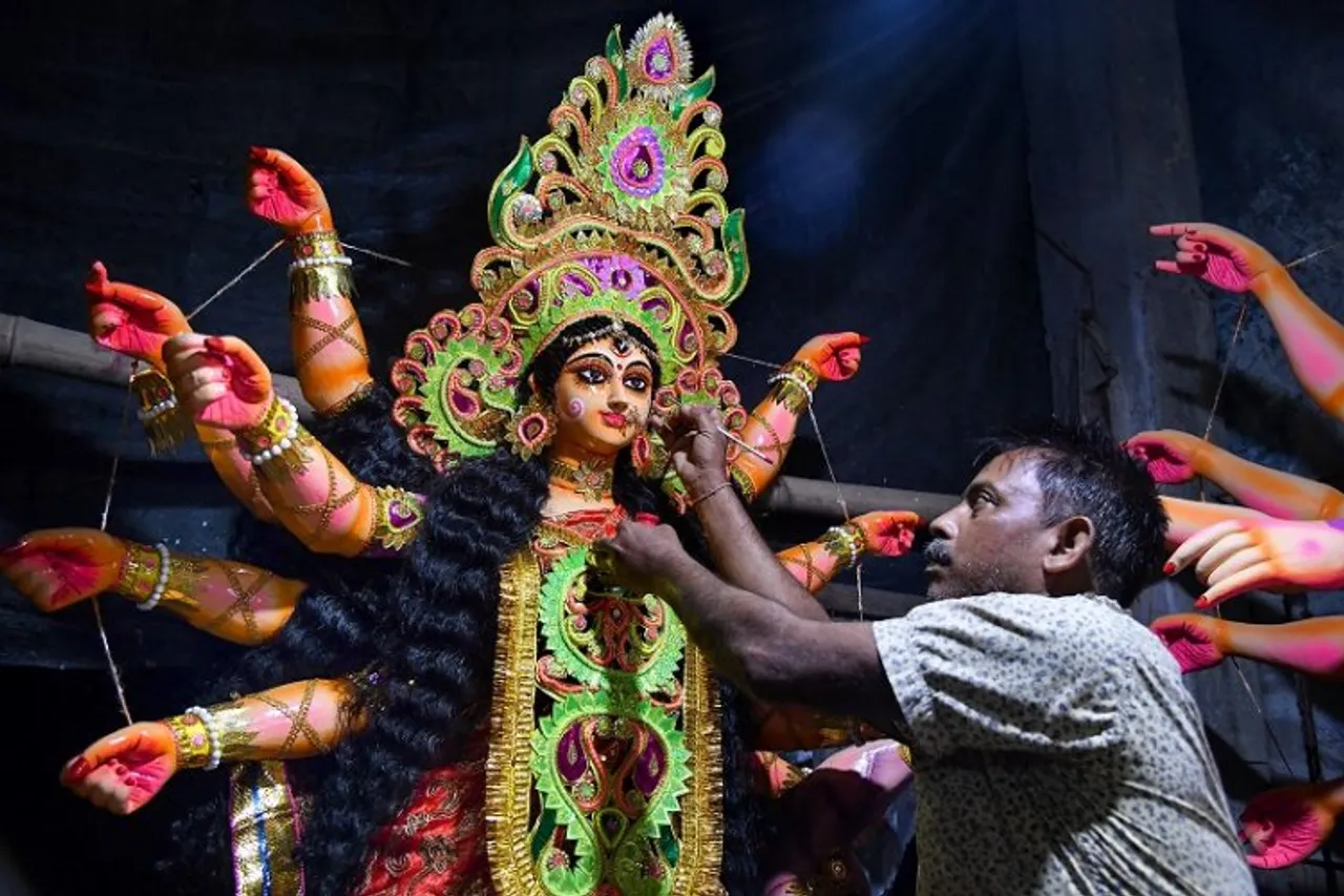 Artist giving final touch to Durga Idol